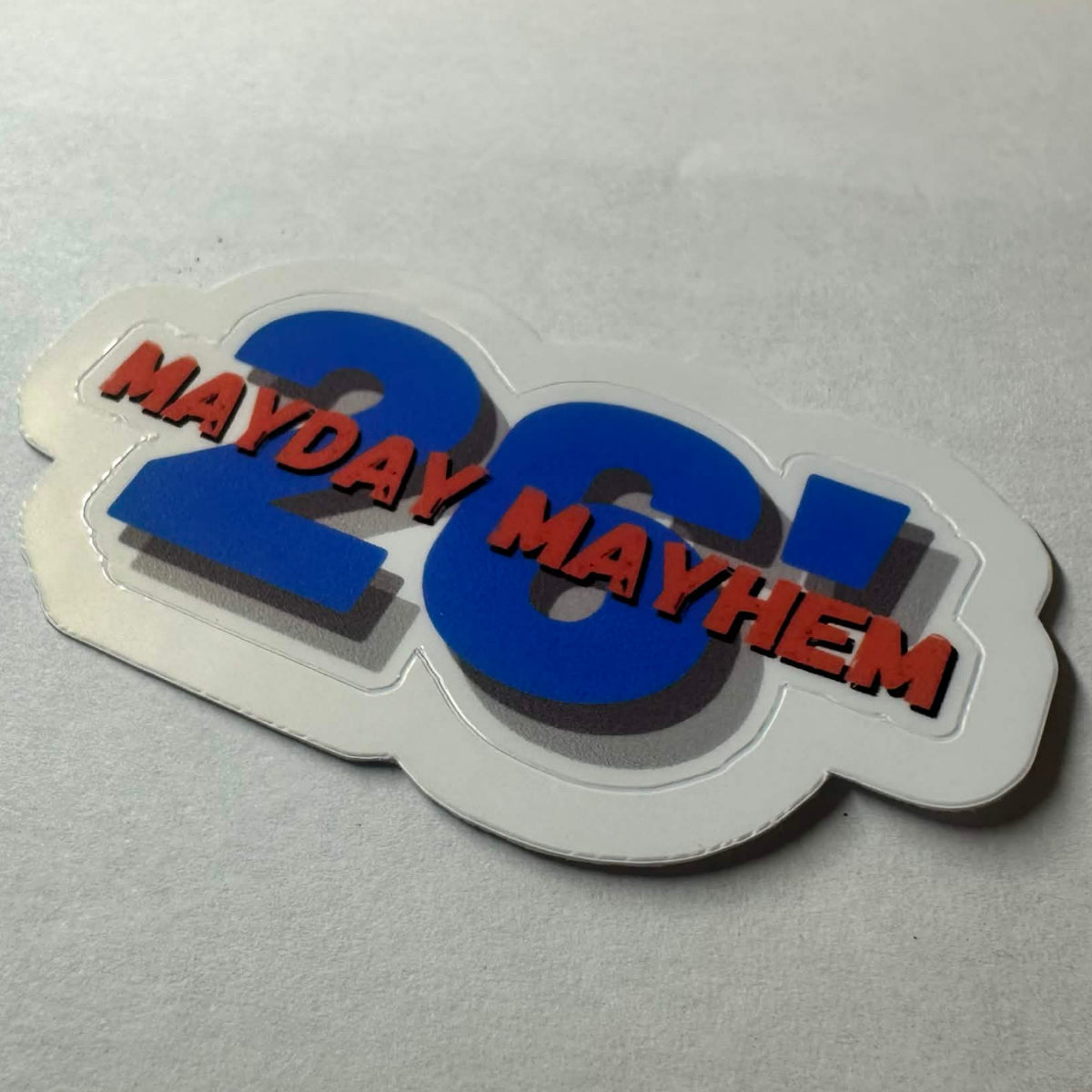 Sticker with '26 Mayday Mayhem' text on a gray background